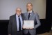 Dr. Nagib Callaos, General Chair, giving Dr. Michele Staiano an award certificate in appreciation for his presentation oriented to inter-disciplinary communication entitled: "SeMantic Model-To-Model Translation to Capture the Nexus Complex Predicate."